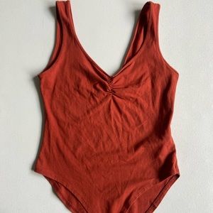 Burnt Orange Body suit. Size M